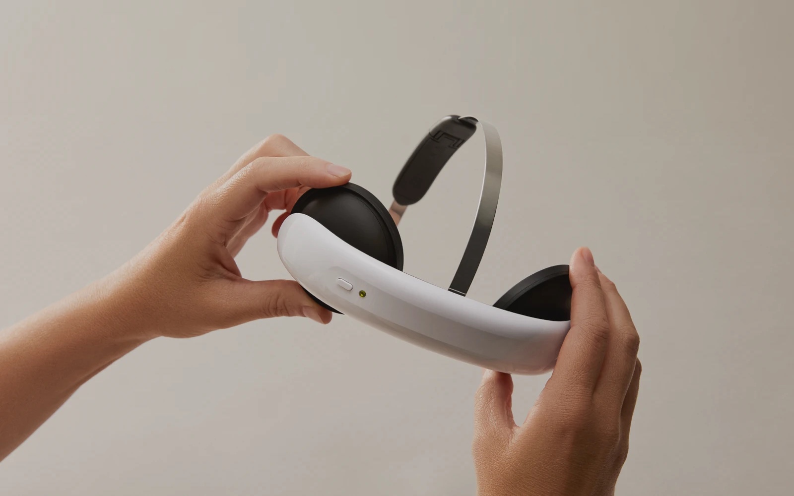Hands holding the Flow headset